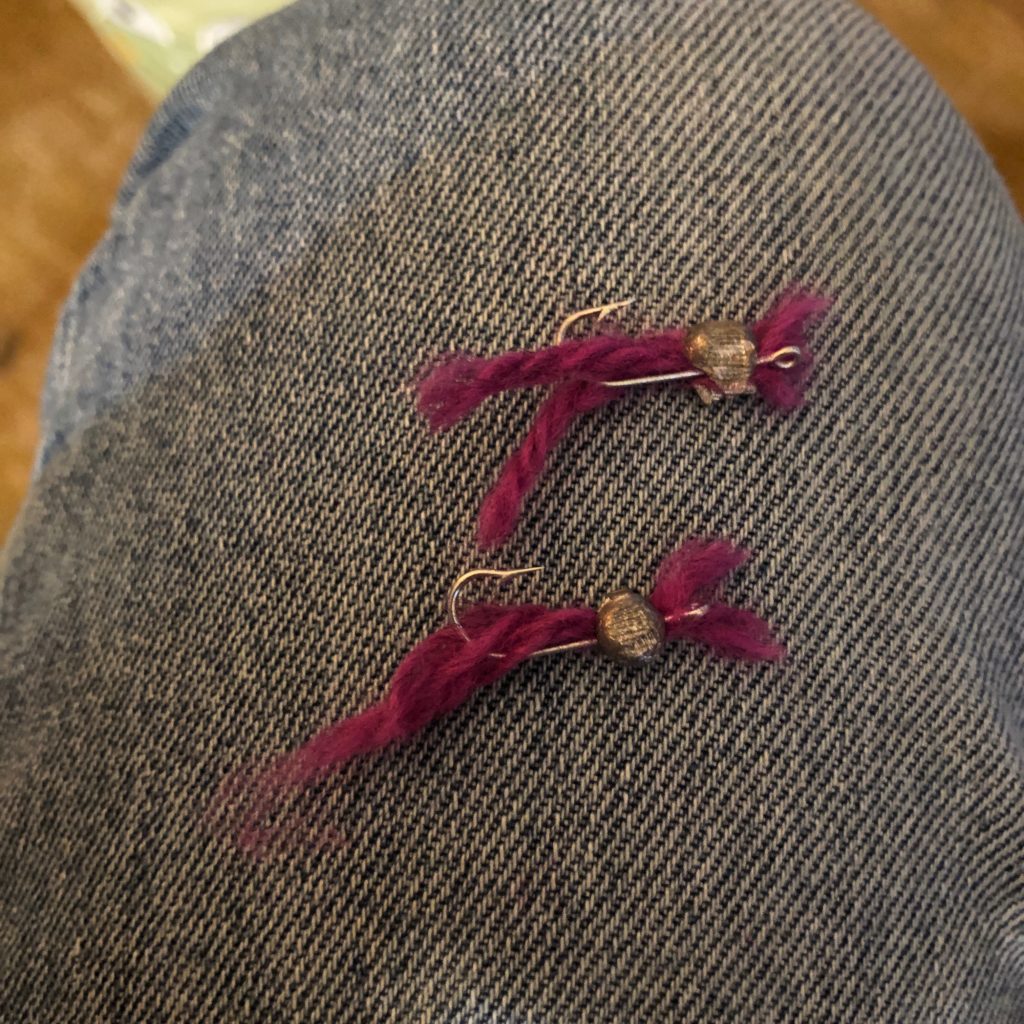 Homemade fishing lures made with yarn.